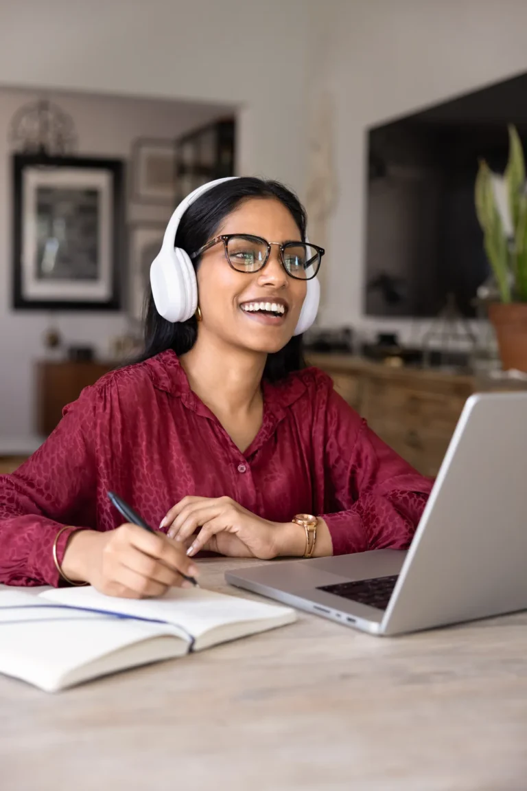 Adult learner smiling while studying the West Virginia real estate course online at home